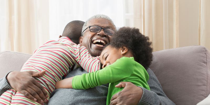 grandchildren hugging grandfather