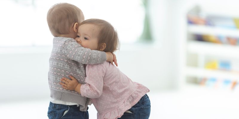 two toddlers hugging