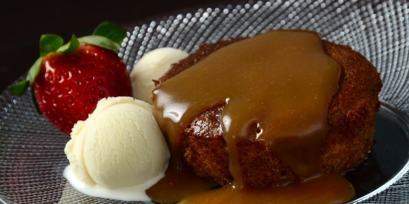 Stick Toffee Pudding served with strawberry and icecream.