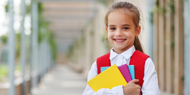 a student holding school material.