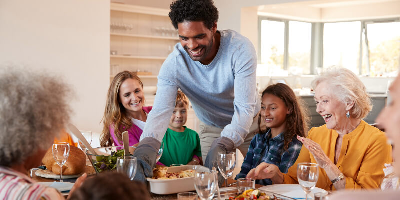 family and friends enjoying dinner